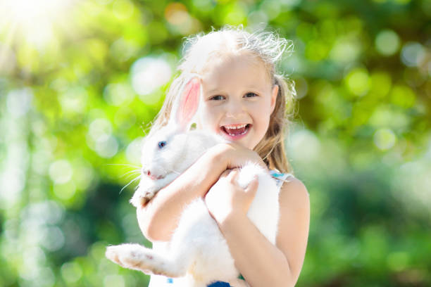 istock Child with rabbit. Easter bunny. Kids and pets. 924481100