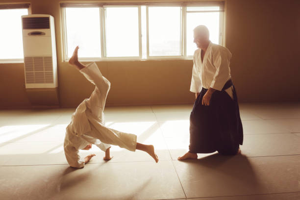 istock Teen boy with his sansei practicing in dojo 924486310