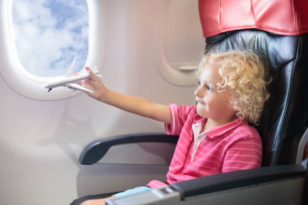 istock Child flying in airplane. Flight with kids. 924486744