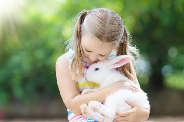 istock Child with rabbit. Easter bunny. Kids and pets. 924487138