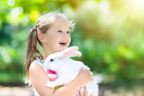 istock Child with rabbit. Easter bunny. Kids and pets. 924487902