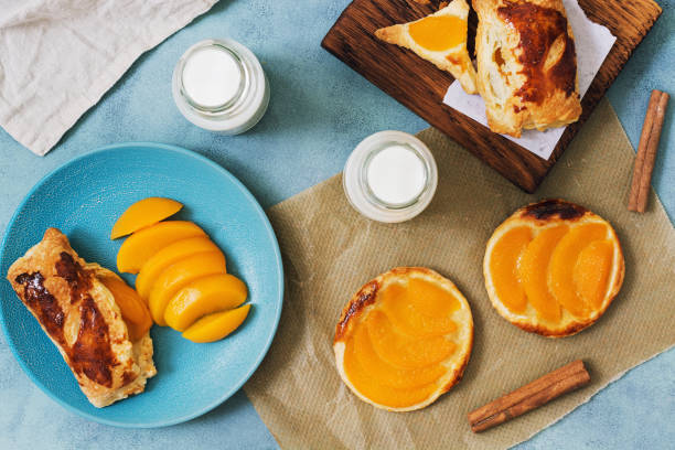 istock Peach pie on a gray background is served with milk. View from above. 924490924