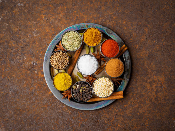 Mix spices on round metal plate - coriander seeds, ground red pepper, salt, black pepper, rosemary, turmeric, curry. Top view, close up, metall rusty background. Mix spices on round metal plate - coriander seeds, ground red pepper, salt, black pepper, rosemary, turmeric, curry. Top view, close up, metall rusty background. russian food stock pictures, royalty-free photos & images