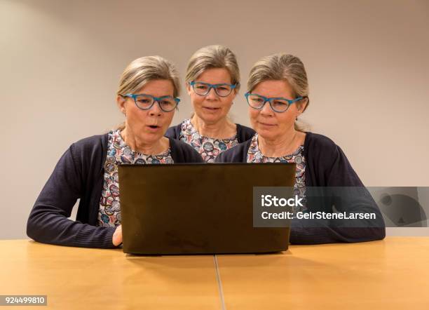 Three Clones Of One Woman With Glasses Working With A Pc Stock Photo - Download Image Now