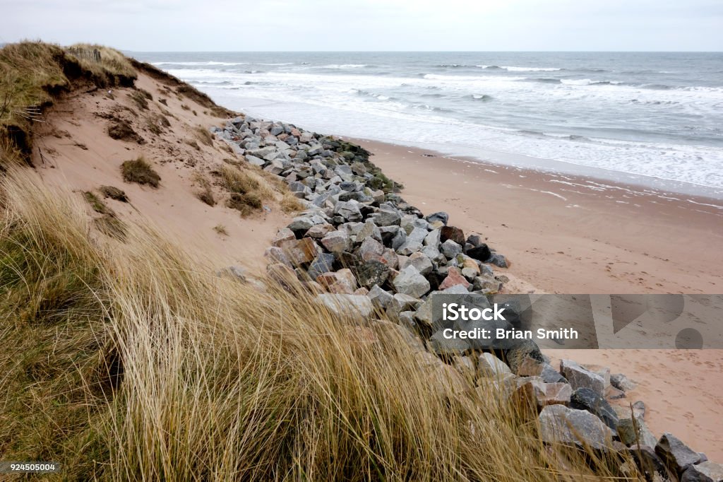 Coastal Erosion at Montrose Beach, Angus, Scotland. Rock armour trying to ease coastal erosion at Montrose, Angus, Scotland. Montrose - Scotland Stock Photo