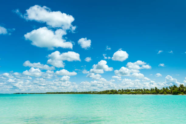 A dramatic blue sky with clouds above the Caribbean sea and the tropical island Sosua in the Dominican Republic