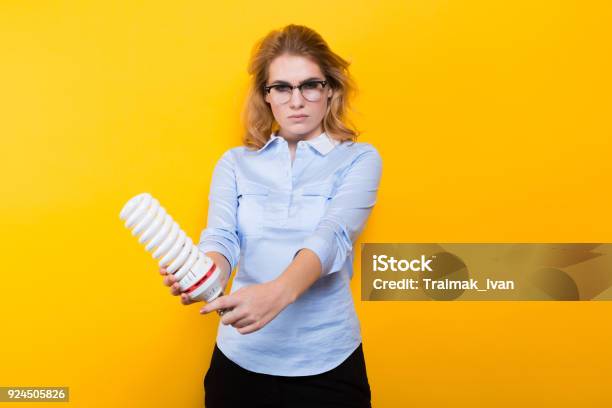 Attractive Woman With Energy Saving Bulb Stock Photo - Download Image Now - Adult, Adults Only, Blond Hair