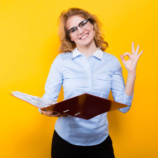 istock Smiling woman with big folder 924505880