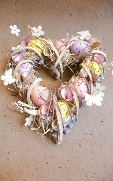 istock Easter egg wreath in heart shape on brown background 924508192