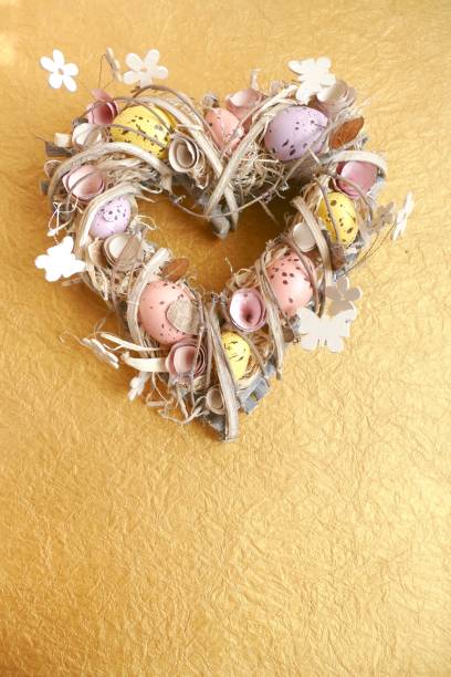 istock Easter egg wreath in heart shape on golden background 924508328