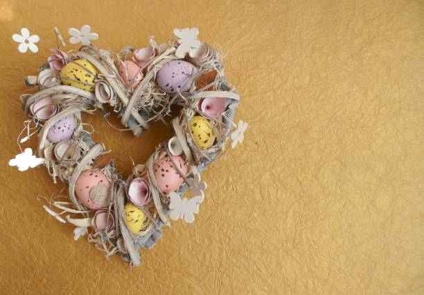 istock Easter egg wreath in heart shape on golden background 924508460