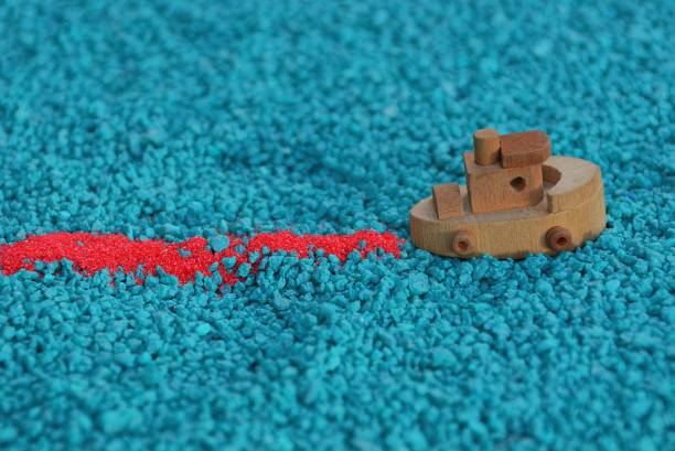 istock small wooden boat on blue small stones 924509462