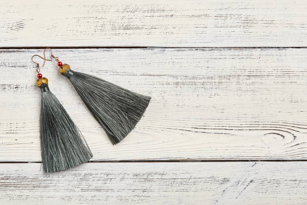 istock Gray tassel earrings on white background 924512594