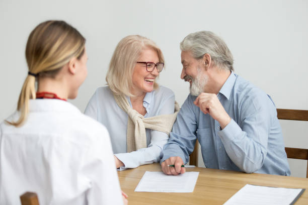 istock Happy aged couple laughing ready to sign document at meeting 924512824