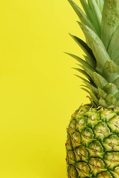 pineapple on yellow stock photo