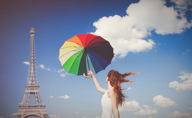 istock Young redhead girl with umbrella at Eiffel tower background 924515822