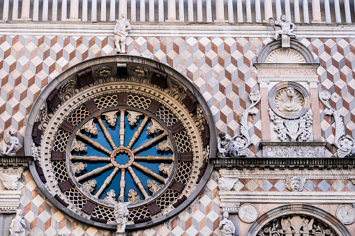 Rose window with tarsia and polychrome marble decorations on Colleoni Chapel or Cappella Colleoni church in Bergamo, Italy