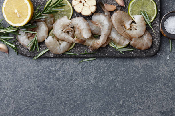 istock Cooking raw tiger prawns with herbs and spices 924516962