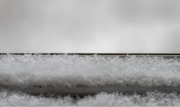 istock the snow falls on the windowsill. Close-up 924517100