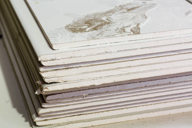 istock Footprints from workers shoes on the dust from construction on the sheets of plasterboard (drywall) in room  is under construction, remodeling, renovation, extension, restoration and reconstruction 924517808