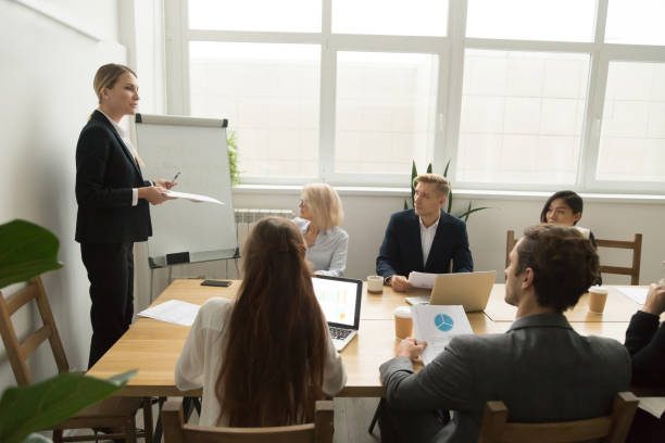 istock Female team leader discussing corporate plan at multiracial team meeting 924520186