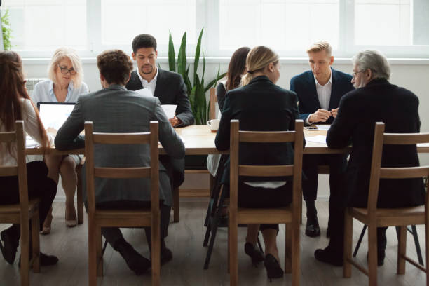 istock Multi-ethnic business team sitting at conference table, negotiations and teamwork 924520224