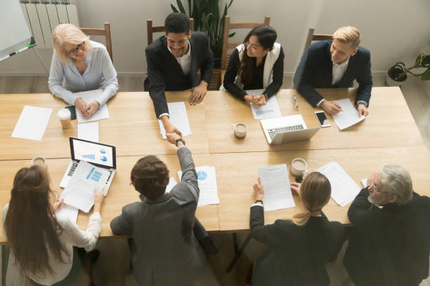 istock Multiracial businessmen shaking hands at diverse group meeting, top view 924520242