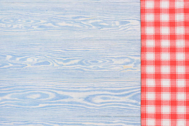istock Red towel over wooden kitchen table. View from above with copy space 924521732