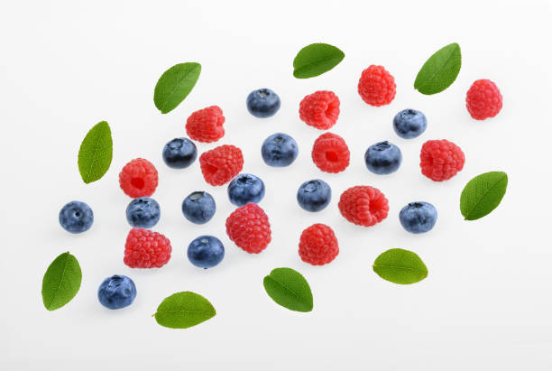 istock Raspberries and blueberries on white background.  top view 924524386