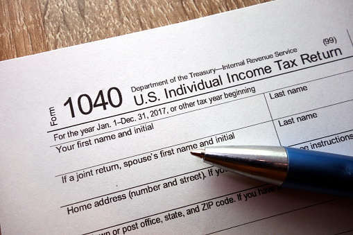 1040 tax form and pen, taxation concept