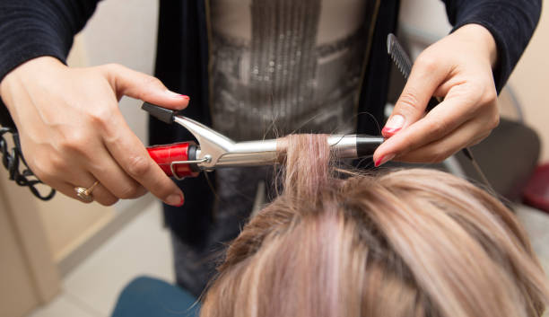 istock wrap hair curling in a beauty salon 924531636