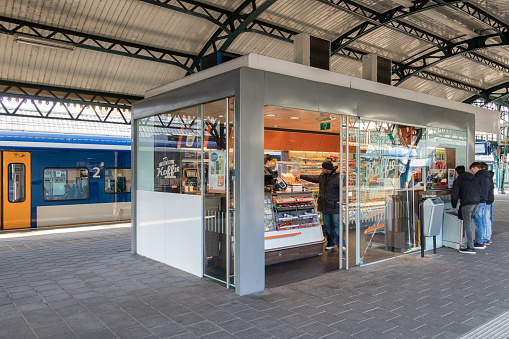 Den Bosch, The Netherlands - February 01, 2018: Customers buying sweets at kiosk in Den Bosch train station