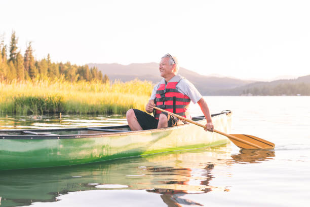 istock Senior man canoeing on a beautiful Idaho lake 924532088