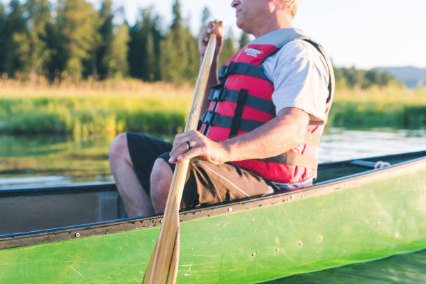 istock Senior man canoeing on a beautiful Idaho lake 924532108