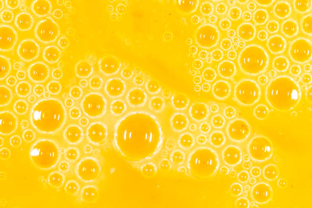 istock foam on a yellow egg yolk as a background. macro 924533364