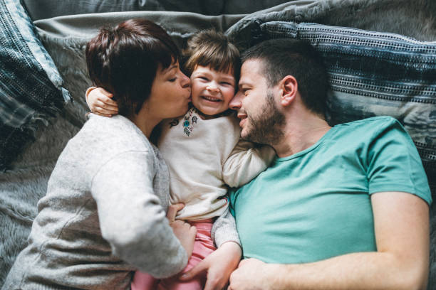istock Happy family in bed room having fun 924533756