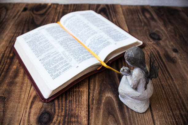 istock angel and bible on a wooden background 924536948