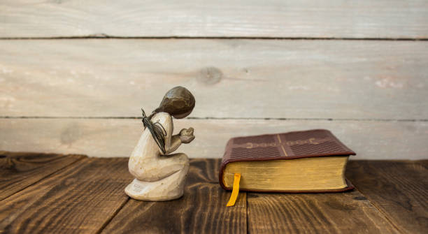 istock angel and bible on a wooden background 924540884