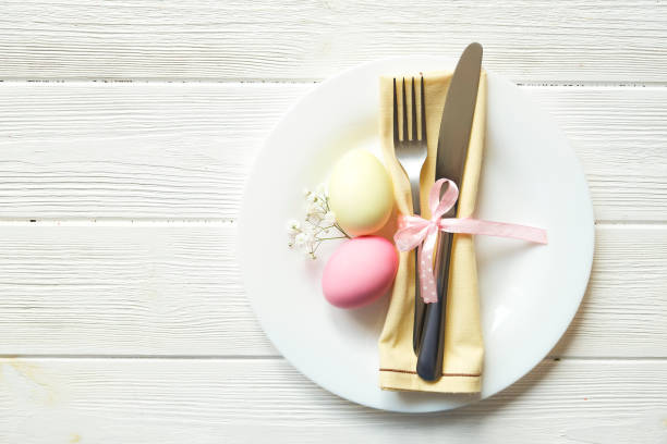 easter laying table appointments, table setting options. silverware, tableware items with festive decoration. fork, knife and flowers. happy easter holiday. - tablesetting imagens e fotografias de stock