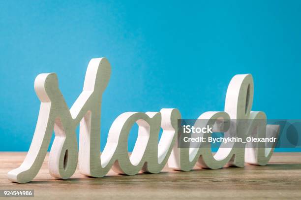 The Word March Carved Of Wood At Blue Background Spring Beginning Concept Stock Photo - Download Image Now