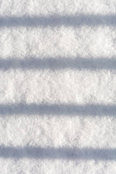 istock shadow in the form of straight lines on a snowy surface, abstract background 924547478