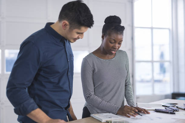 istock Design couple strategize in their modern studio 924547514