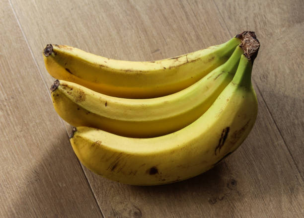 istock Fresh yellow Bananas on wooden background 924547740