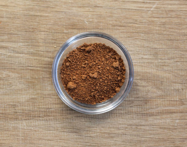 istock Glass bowl with nutmeg on wooden background 924548336