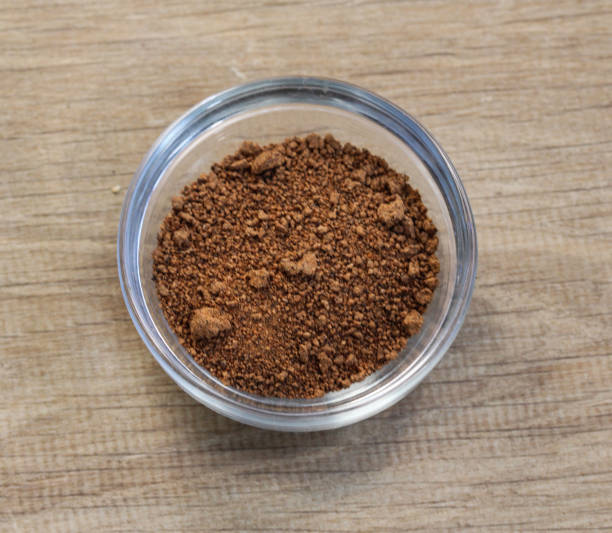 istock Glass bowl with nutmeg on wooden background 924548342