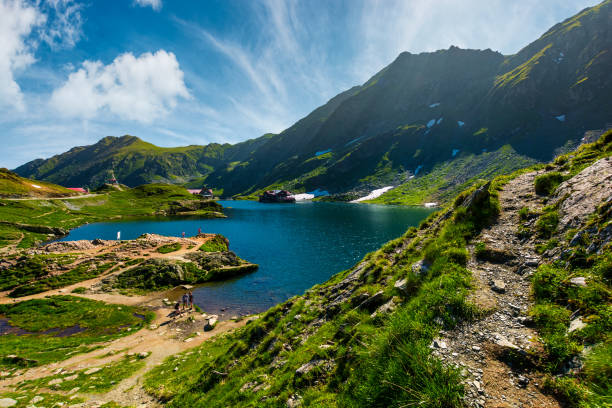 lake Balea in Fagaras mountains on a bright sunny lake Balea in Fagaras mountains on a bright sunny day. amazing summer landscape of one of the most visited landmarks in Romania balea lake romania stock pictures, royalty-free photos & images