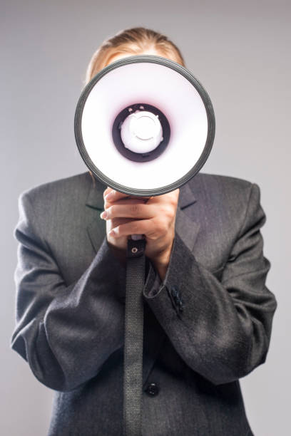 istock Communication Concept: blond Female Holding Big White Megaphone Against Face. 924554782