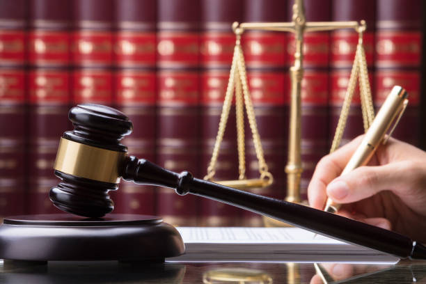 istock Gavel In Front Of Person Writing On Document 924554864