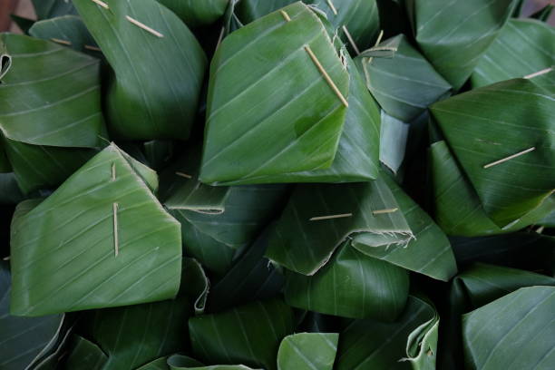 istock Sticky rice Thai custard is Thai dessert which wrap by banana leaf, within banana leaf is contain Sticky rice Thai custard 924555174