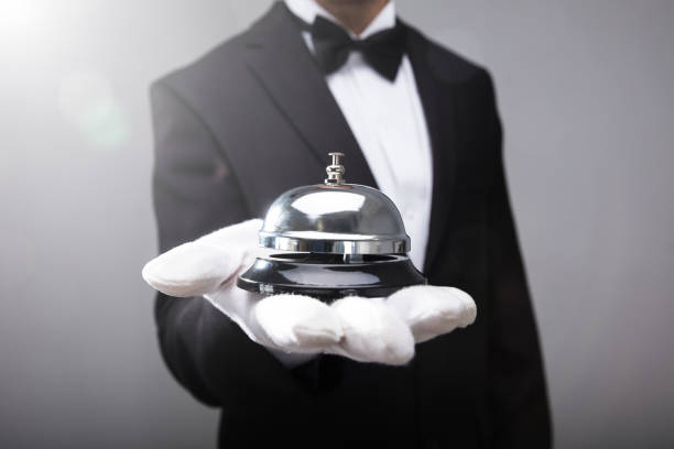 Waiter Holding Service Bell Close-up Of A Waiter's Hand Holding Service Bell concierge photos stock pictures, royalty-free photos & images